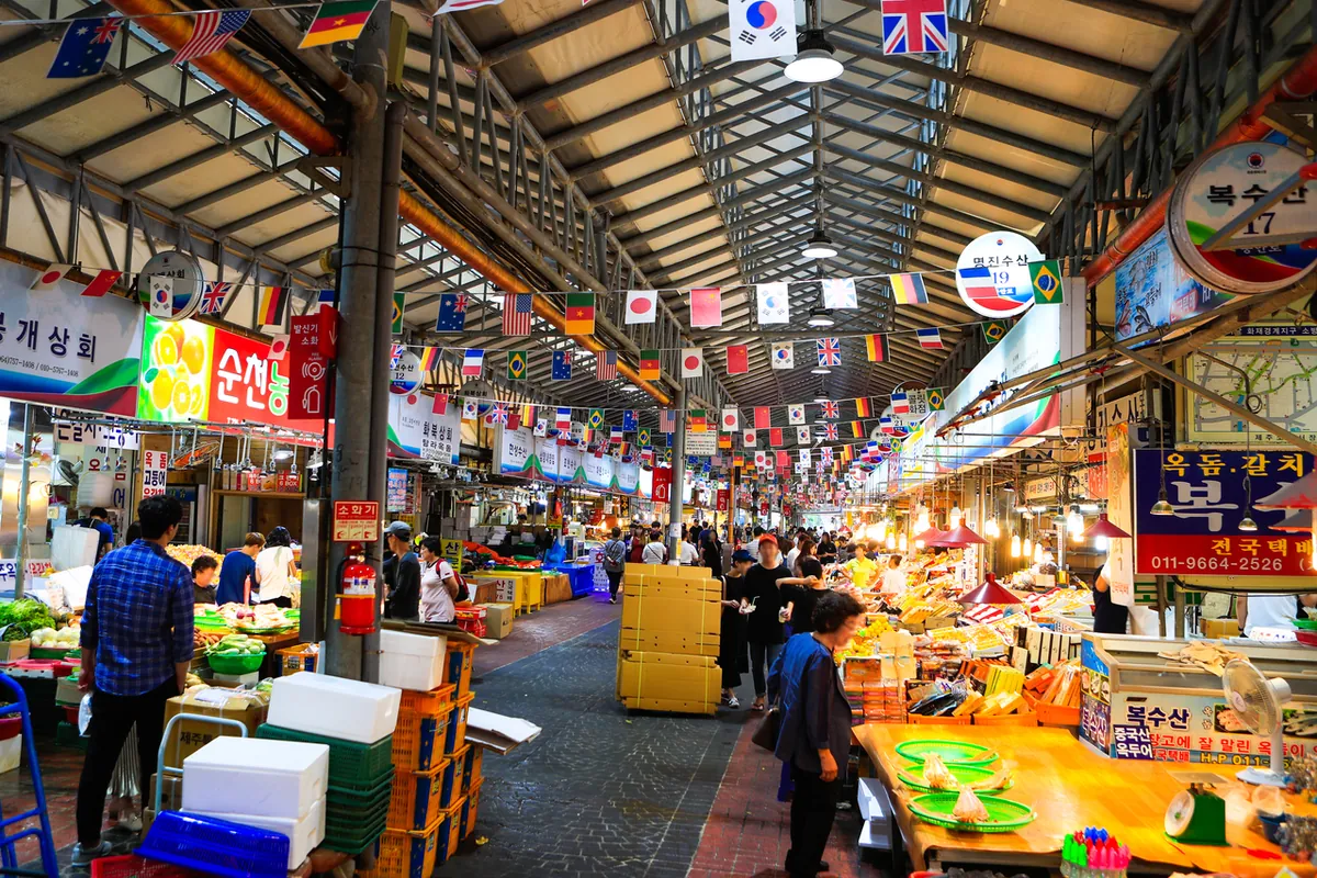 Covered Dongmun Market aisle lined with food and produce stalls