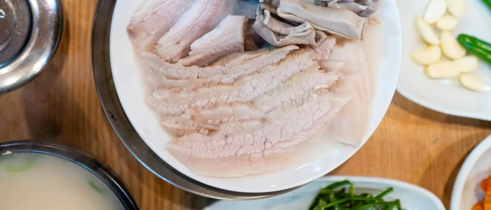 Sliced pork and broth served as a Busan-style dwaeji-gukbap meal